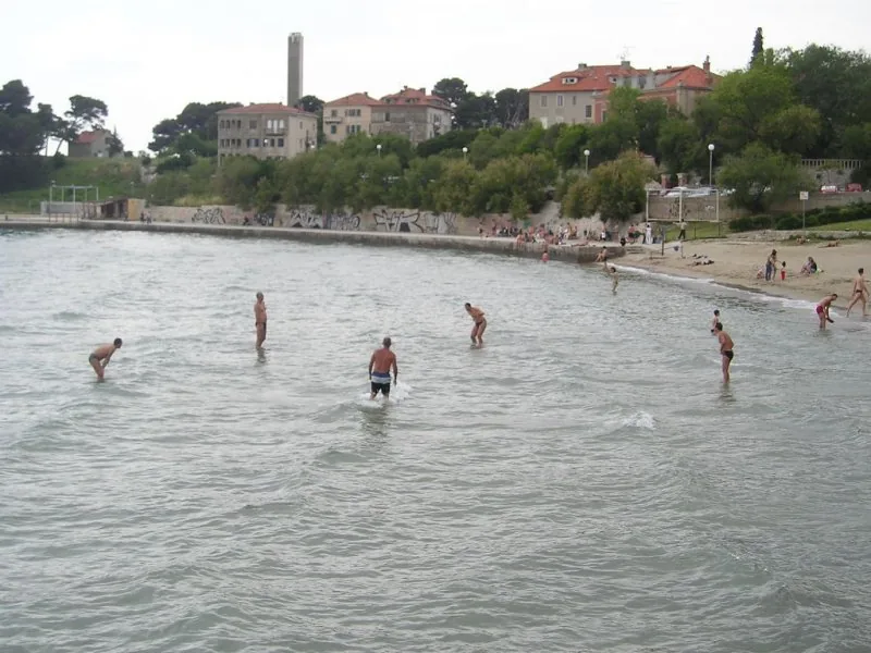 Players standing in the shallow water at Bačvice keeping a small ball in the air