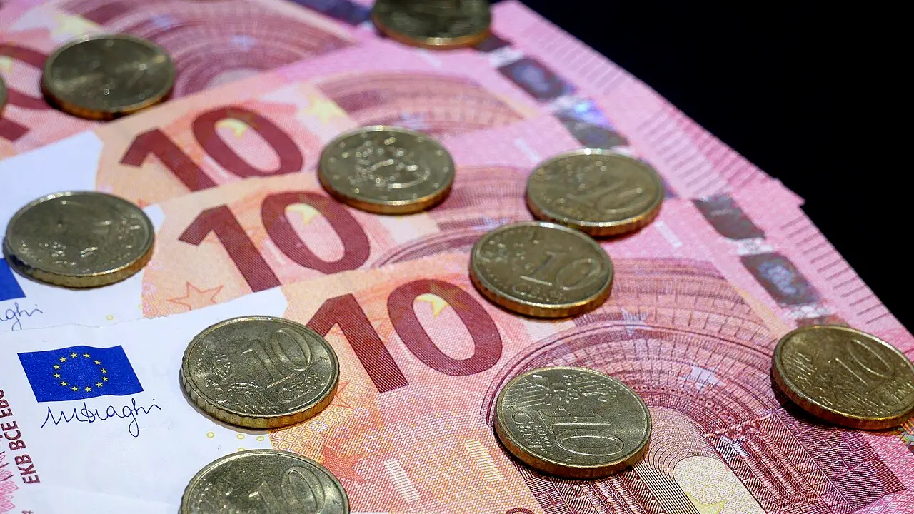 Ten and twenty euro banknotes fanned out with euro cent coins