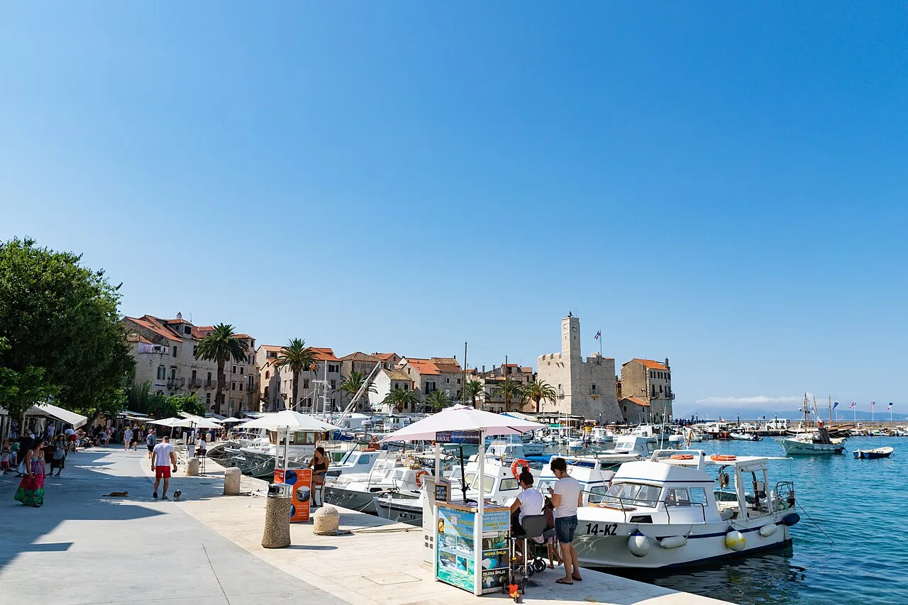 The harbour of Komiža on Vis island, stone houses and small fishing boats along the waterfront