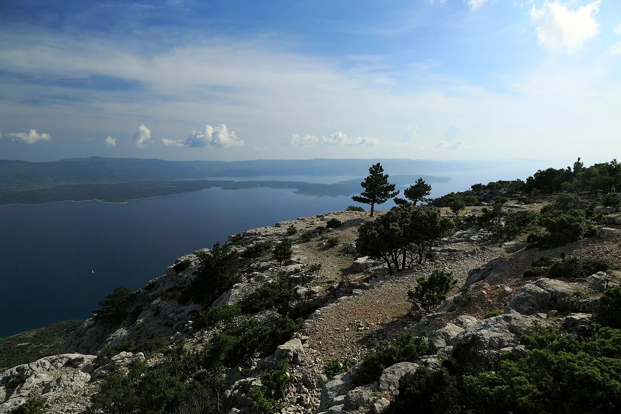 The view from Vidova Gora on Brač across the sea to the long island of Hvar under a blue sky
