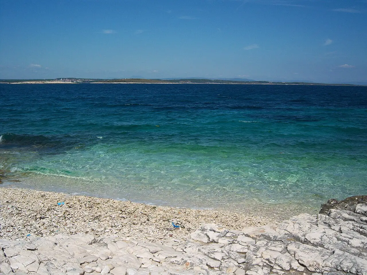 Small pebble beach and turquoise shallows on Cape Kamenjak