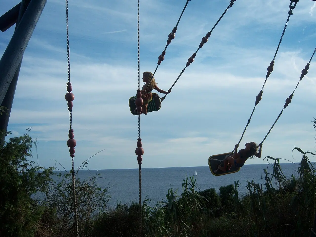 Wooden swing hanging over the sea at the Safari Bar cove on Cape Kamenjak