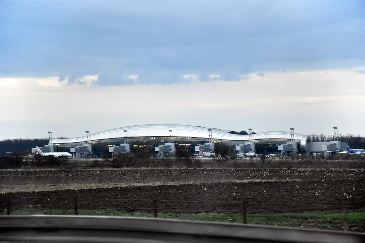 Zagreb Airport terminal seen from the A3 motorway with cars on the access road