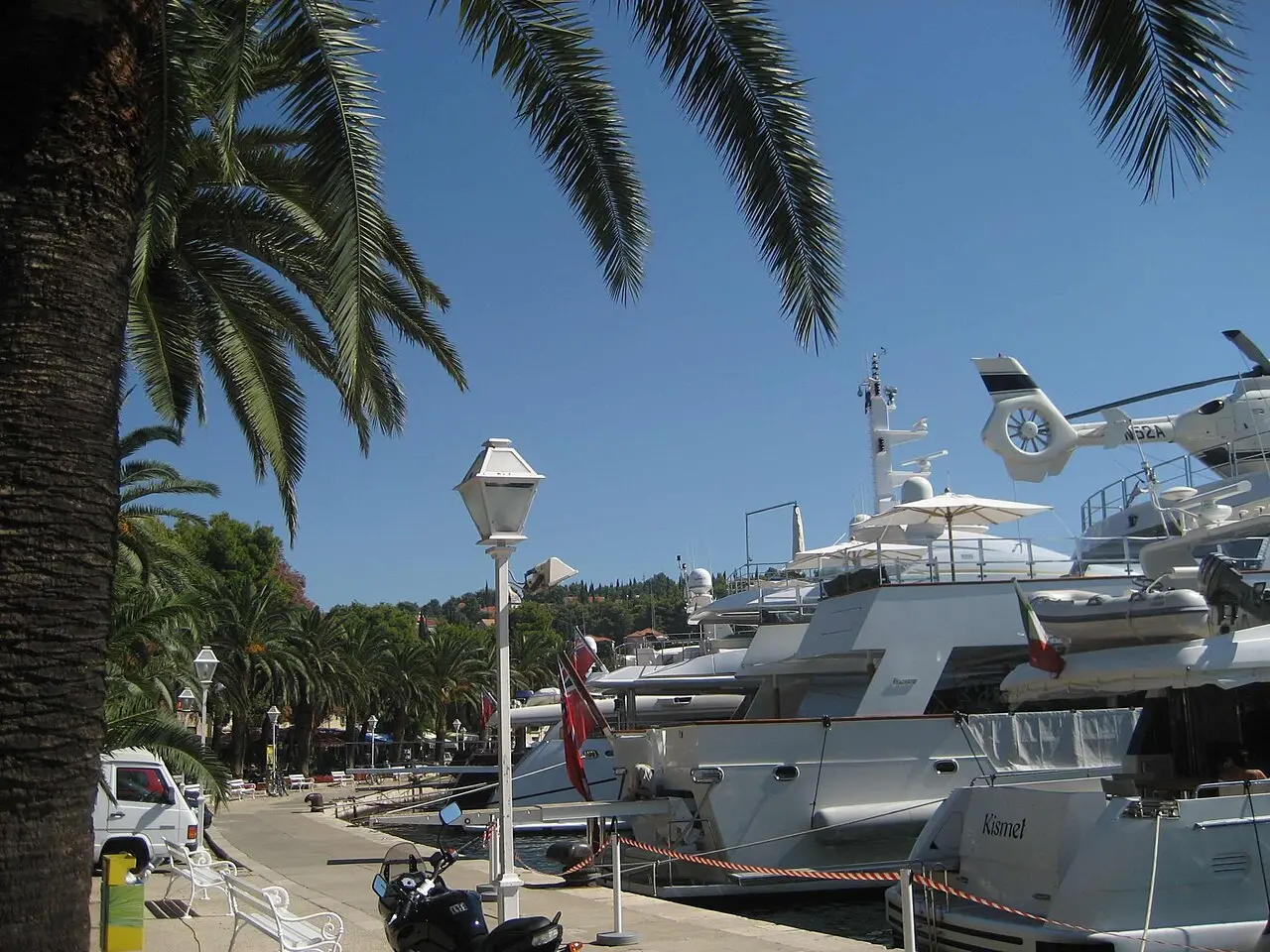 Yachts moored in Cavtat bay with wooded hills behind the harbour