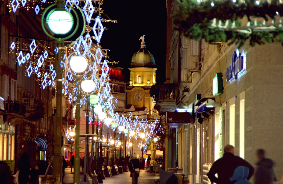 Rijeka's Korzo at night with Advent light decorations over the street and the City Tower lit at the end