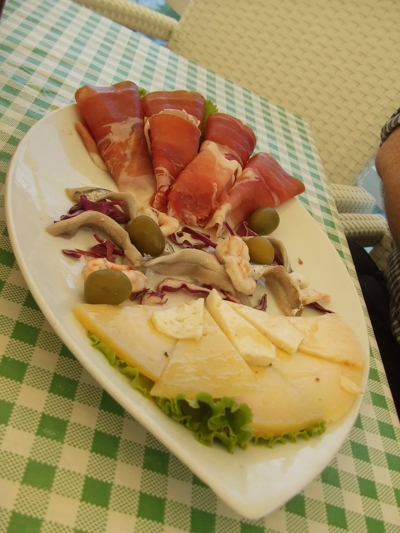 Thin slices of Dalmatian pršut, the smoked dry-cured ham, served with olives