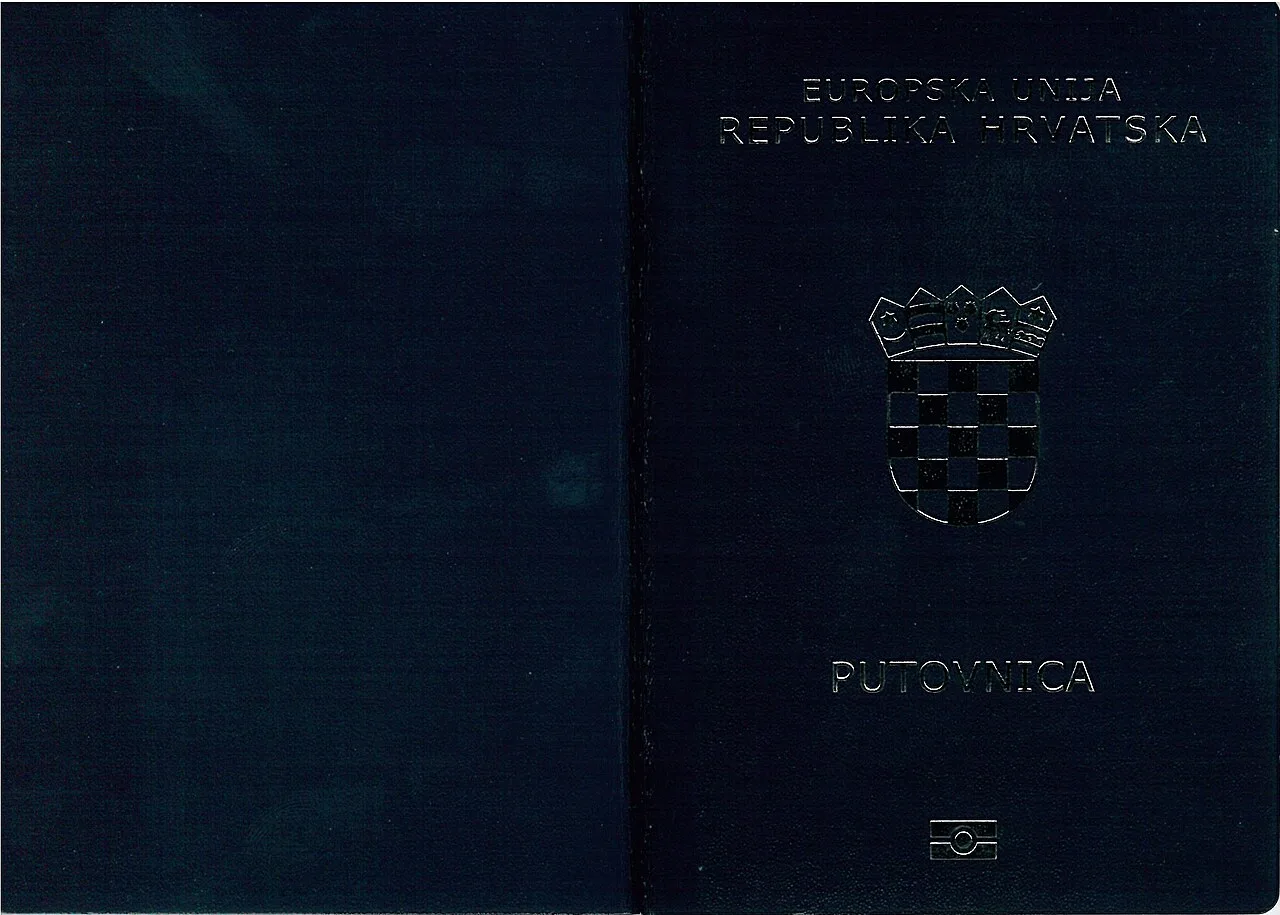 An open Croatian biometric passport on a wooden surface