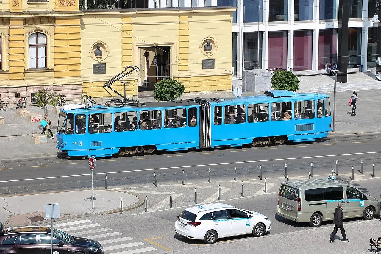 A blue tram passing through Zagreb