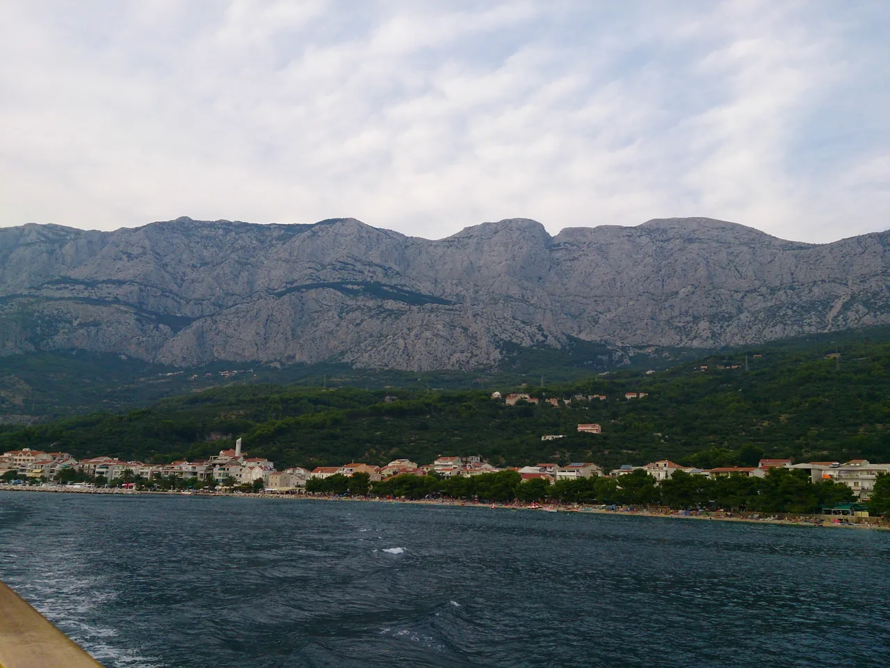 The long, gently shelving pebble beach at Tučepi on the Makarska Riviera, backed by hotels and pine trees