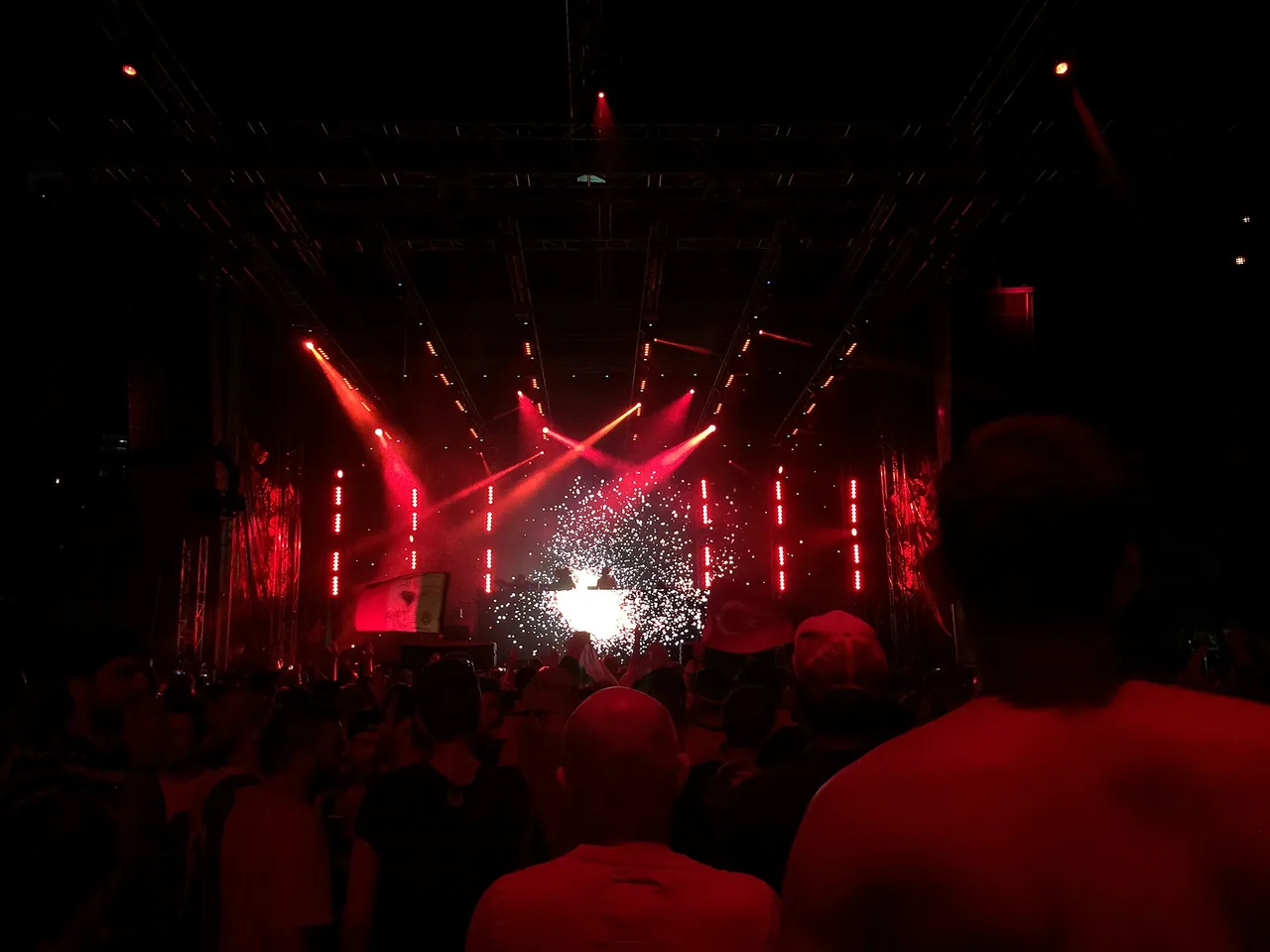 Red stage lights and confetti over the crowd at a night stage of Ultra Europe in Split