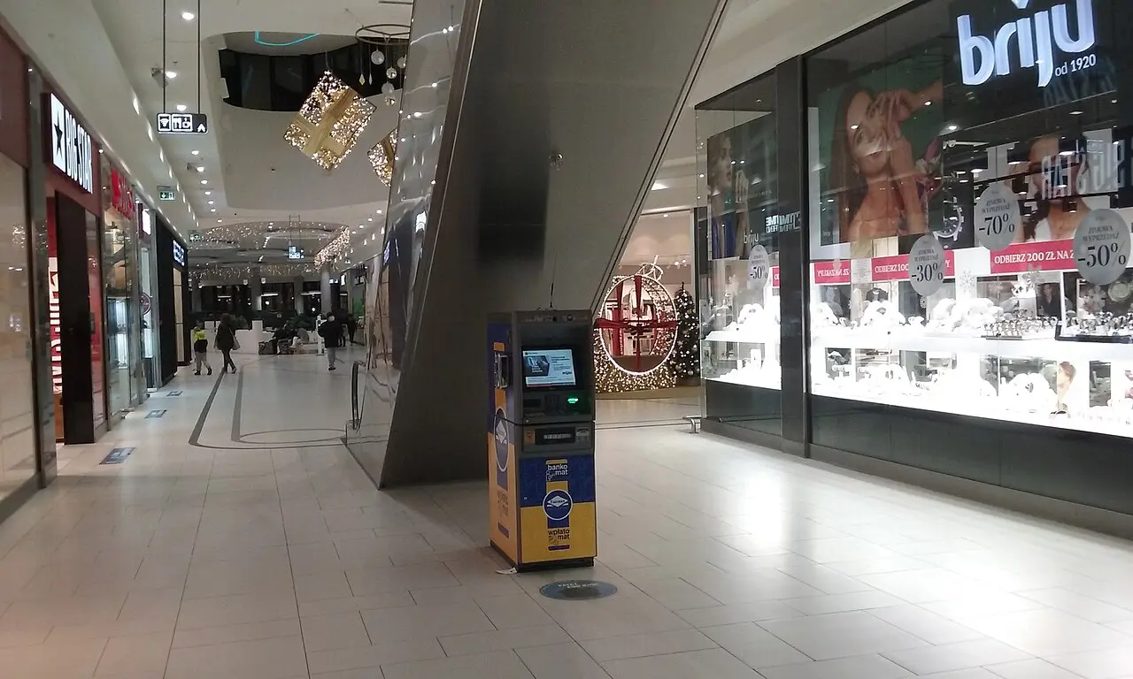 A brightly branded Euronet standalone travel-money ATM and cash machine in a shopping arcade