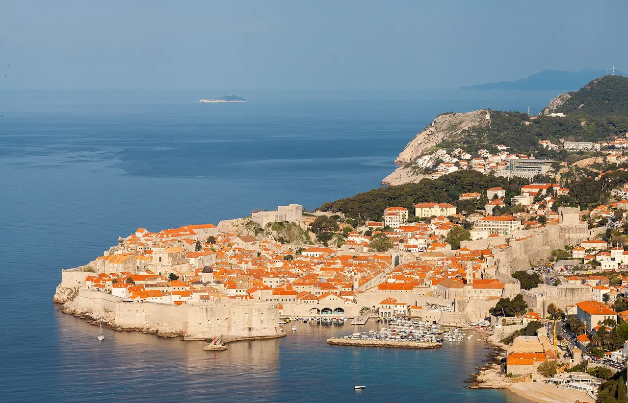 The red-roofed old town of Dubrovnik seen from the city walls, ringed by the Adriatic in summer