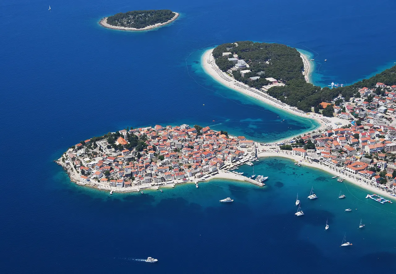 Aerial view of the small peninsula old town of Primošten surrounded by the turquoise Adriatic