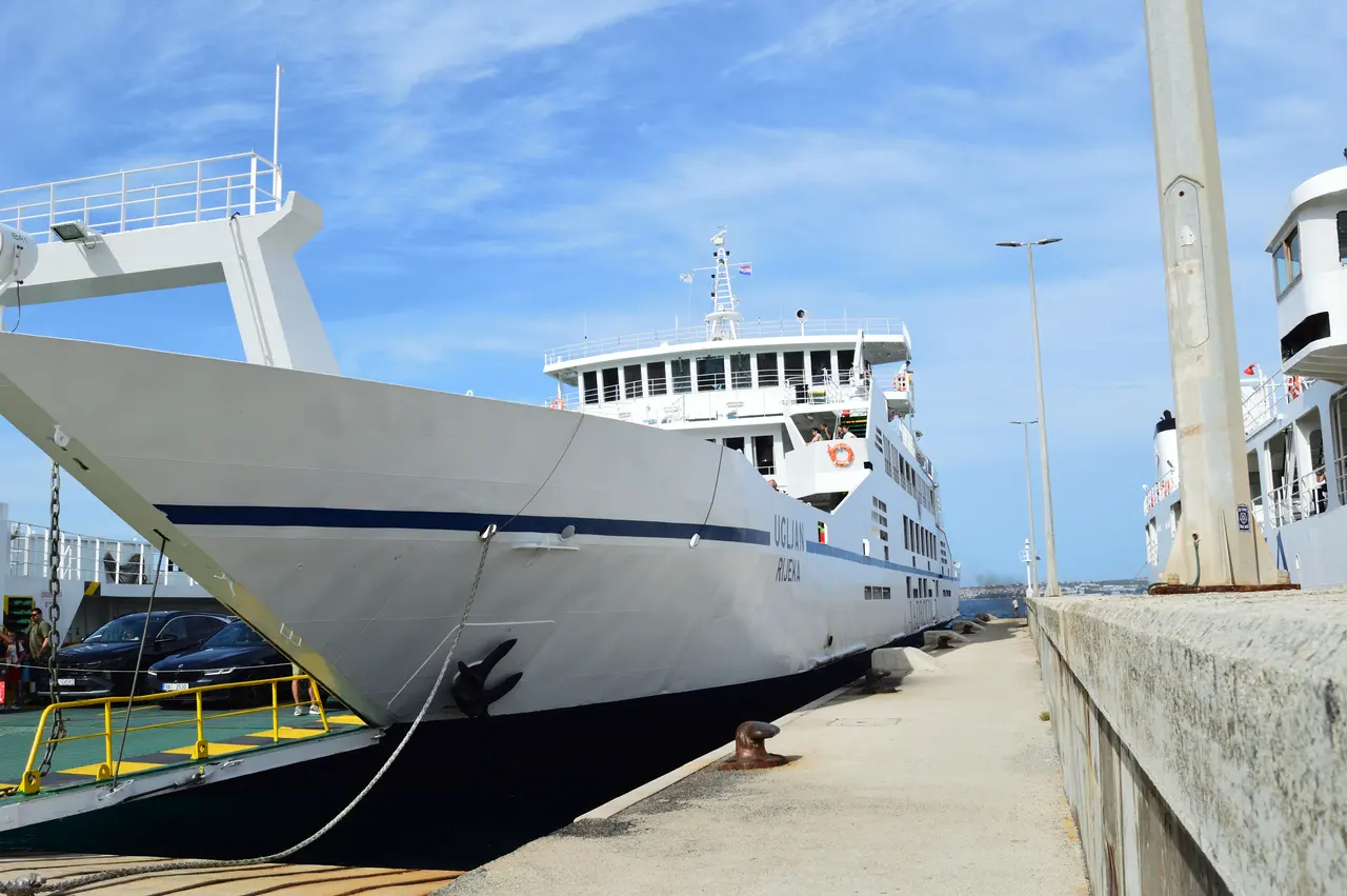 The Jadrolinija car ferry Ugljan docked and loading vehicles at a Croatian port