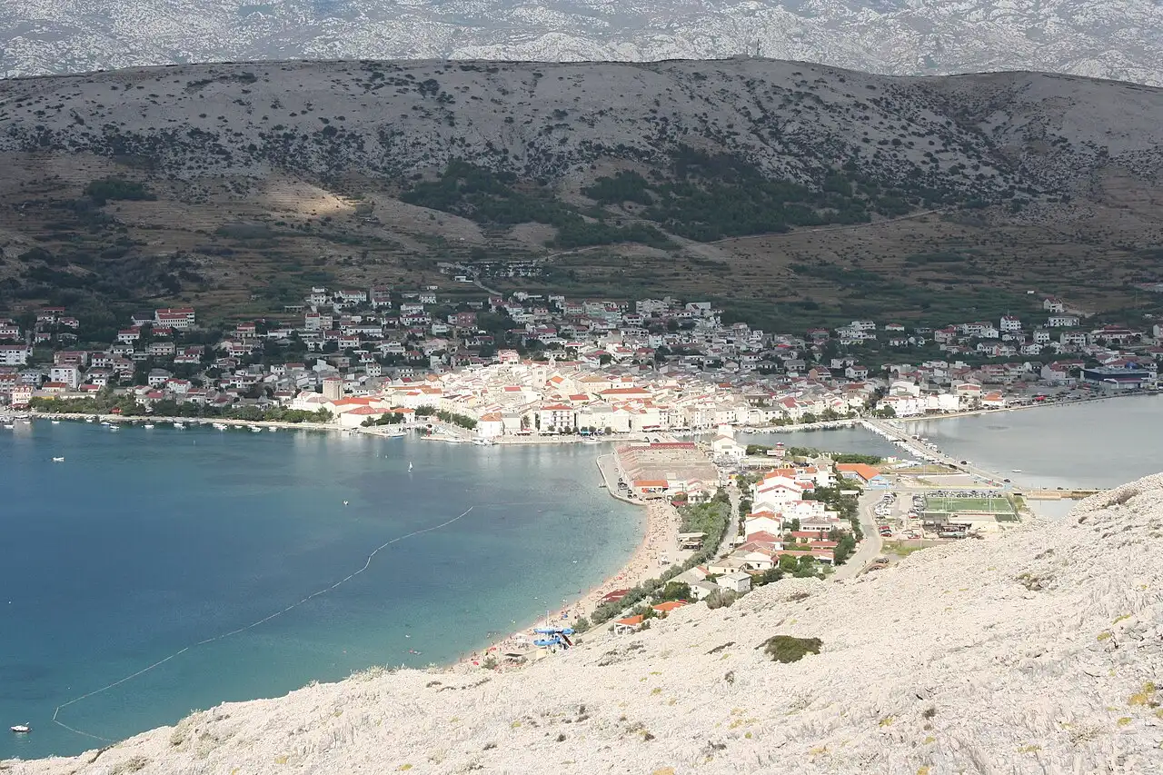 The town of Pag on its bare, pale limestone island under a clear sky