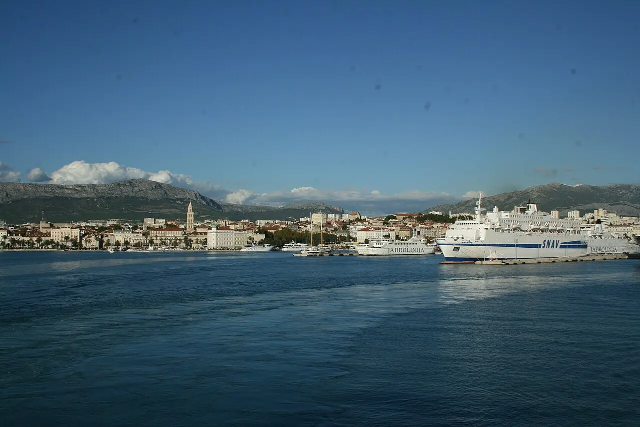 The harbour and old town of Split seen from the water with the Riva waterfront and hills behind