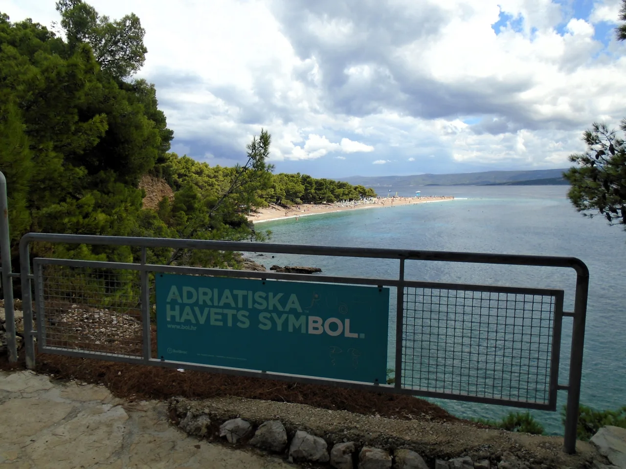 The Zlatni Rat beach spit on Brač curving into clear warm sea