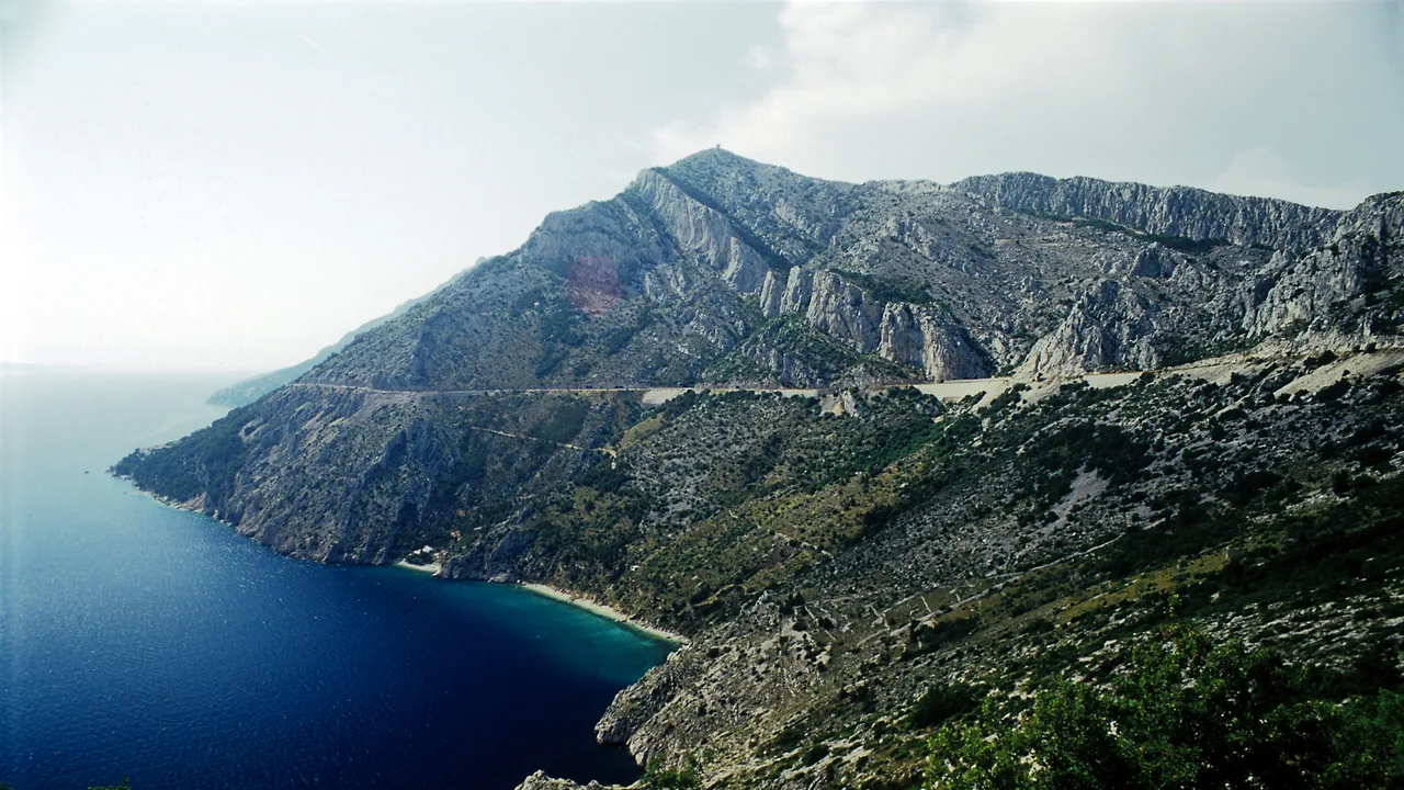 The Adriatic coastal road curving along steep cliffs above the sea in Croatia