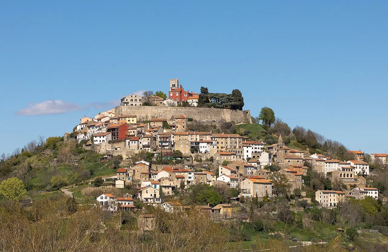 The hill town of Motovun in Istria rising above vineyards and green countryside