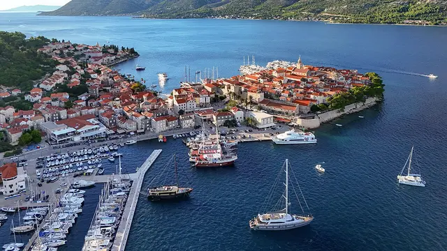 Aerial view of the fortified old town of Korčula on its small peninsula with the marina