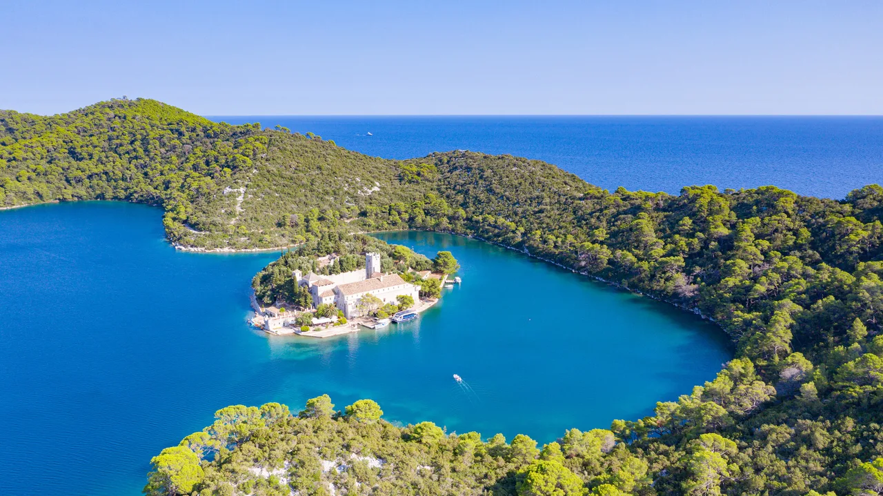 Aerial view of the Benedictine monastery on St Mary islet in the green saltwater lake of Mljet National Park