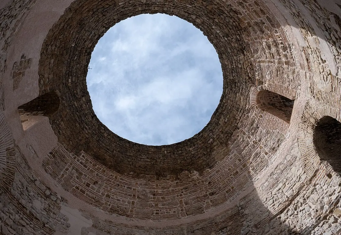 Looking up inside the domed circular Vestibule of Diocletian's Palace in Split, its brick dome open to the sky