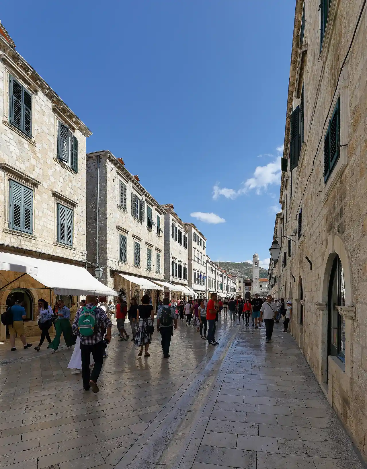 The polished limestone Stradun in Dubrovnik's Old Town, full of pedestrians and lined with shuttered stone buildings