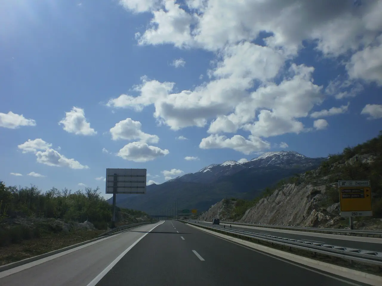 Open lanes of the Croatian A1 motorway through green hills