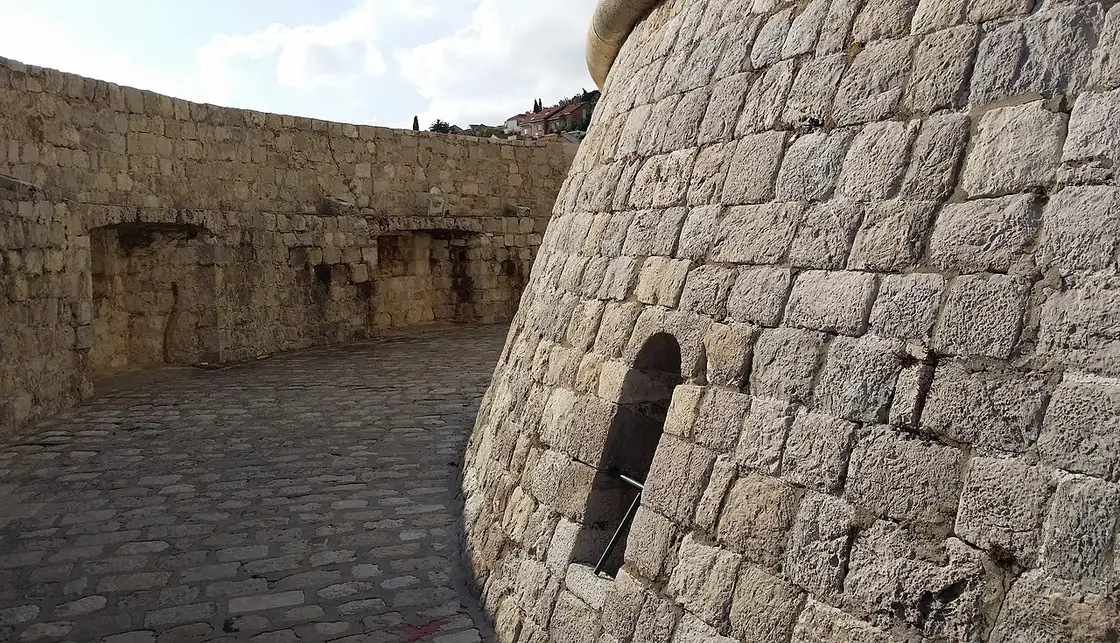 The curved base of Minčeta Tower seen from the Dubrovnik wall walkway, the House of the Undying