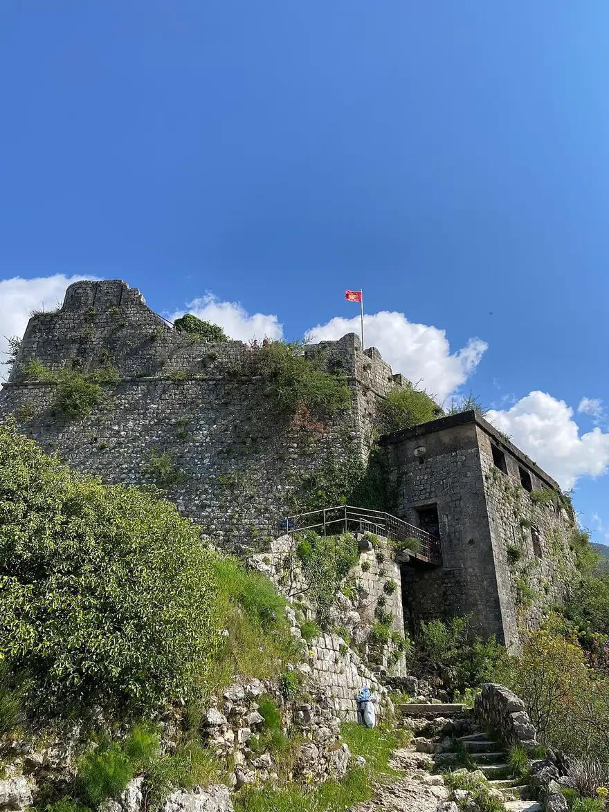 The stone city walls of Kotor climbing the steep mountainside up to the San Giovanni fortress