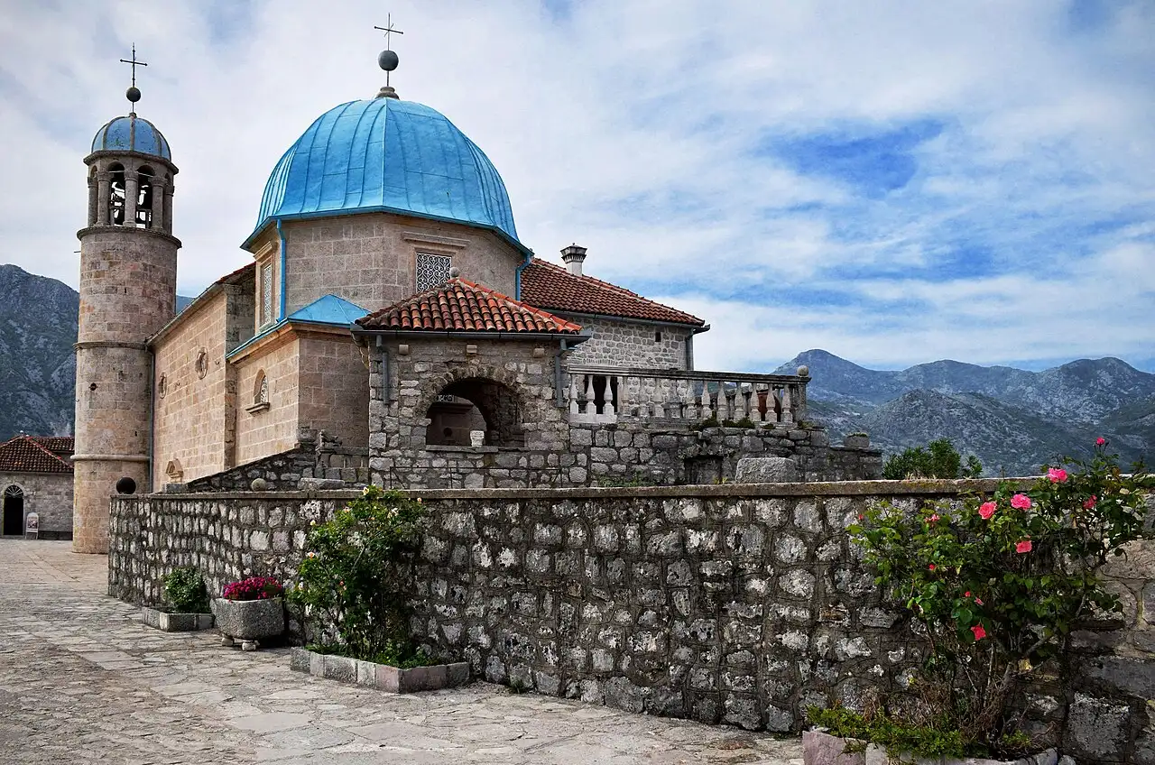 The island church of Our Lady of the Rocks with its blue dome in the Bay of Kotor off Perast