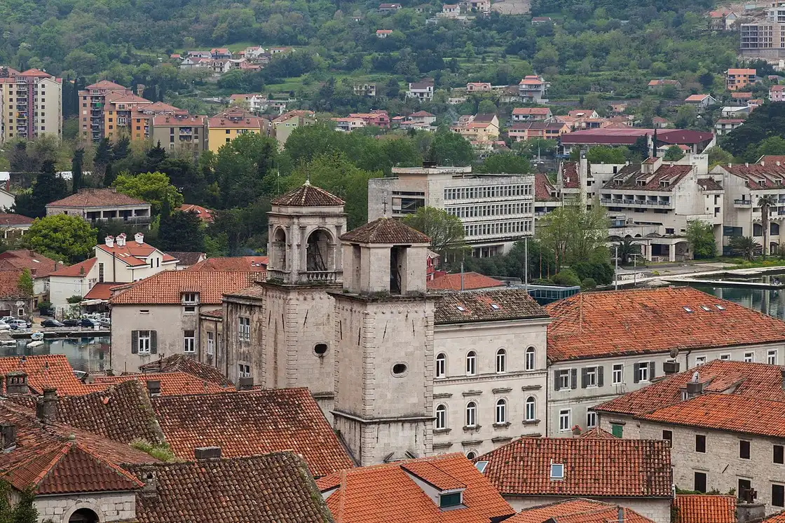 The stone bell towers of St Tryphon Cathedral rising above the terracotta roofs of Kotor old town