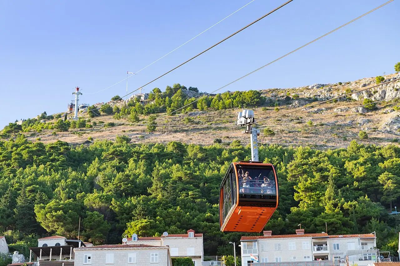 The Dubrovnik cable car climbing the green slopes of Mount Srđ