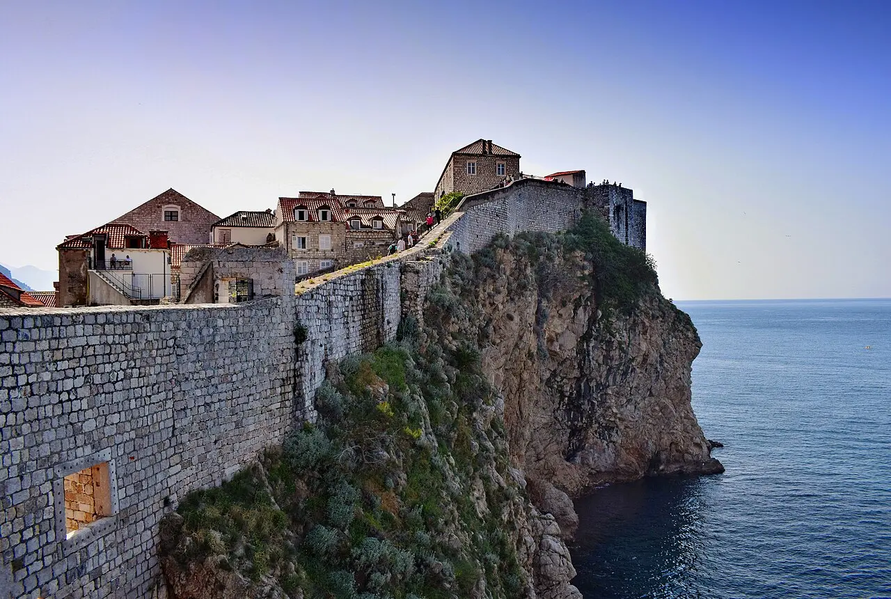 The city walls of Dubrovnik running along the clifftop above the sea