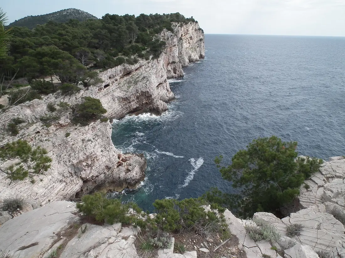 Cliff edge in Telašćica Nature Park with scrub vegetation above the sea