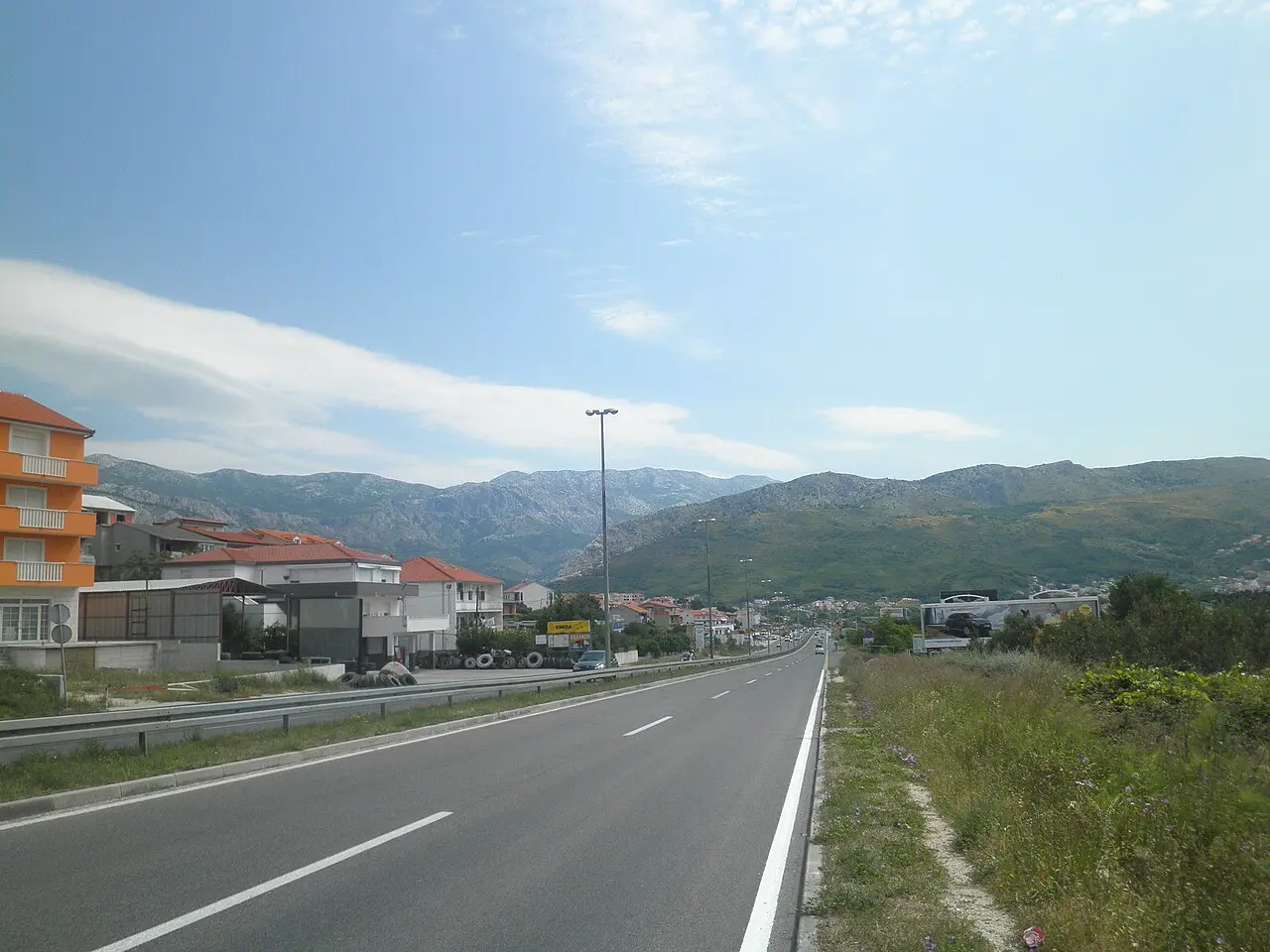 The D8 coastal road near Split with traffic and the Dalmatian mountains behind