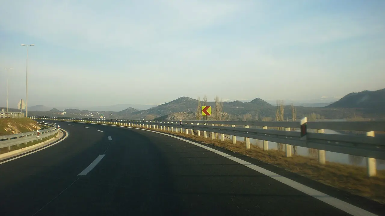 The A1 motorway in Croatia curving through karst mountains under a blue sky