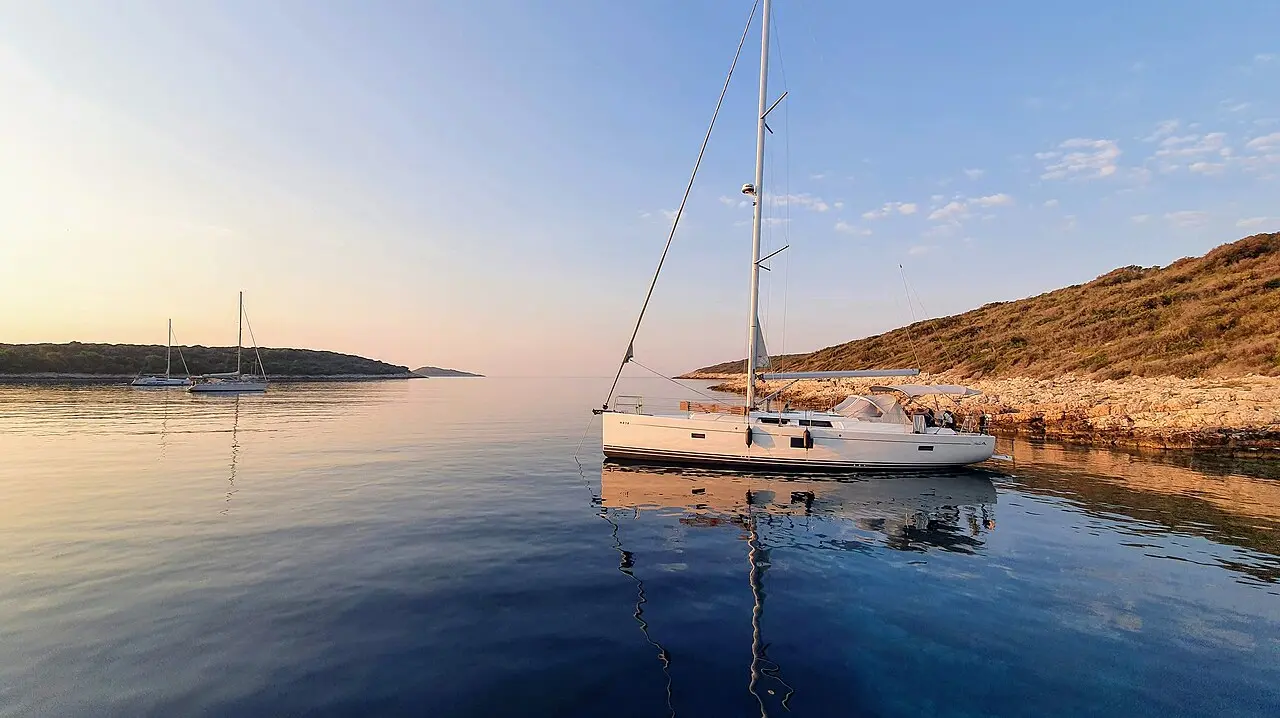Dawn light over the wooded Pakleni islets off Hvar, with calm Adriatic water in the foreground