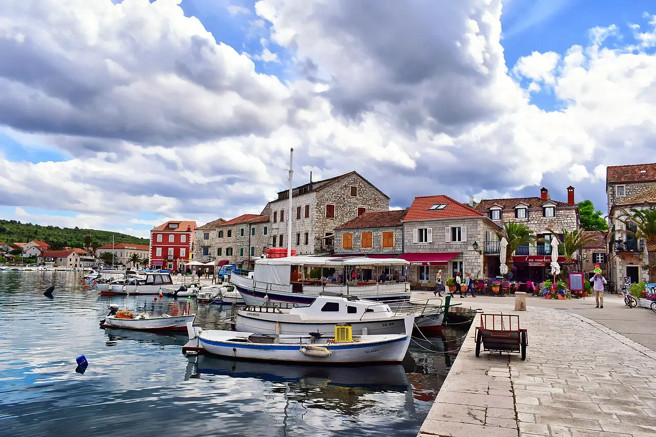 Boats moored along the stone waterfront of Stari Grad's old harbour on Hvar