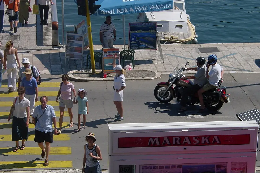 A Croatian police officer in uniform standing on a street in Zadar old town
