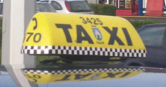 A white taxi car parked on a street in Zagreb, Croatia