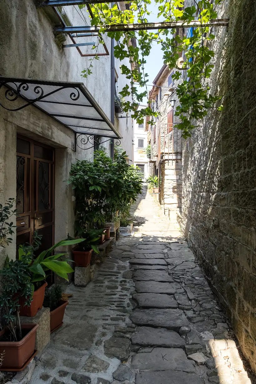 A narrow stone lane in the hilltop artists' town of Grožnjan in central Istria, lined with old houses and galleries