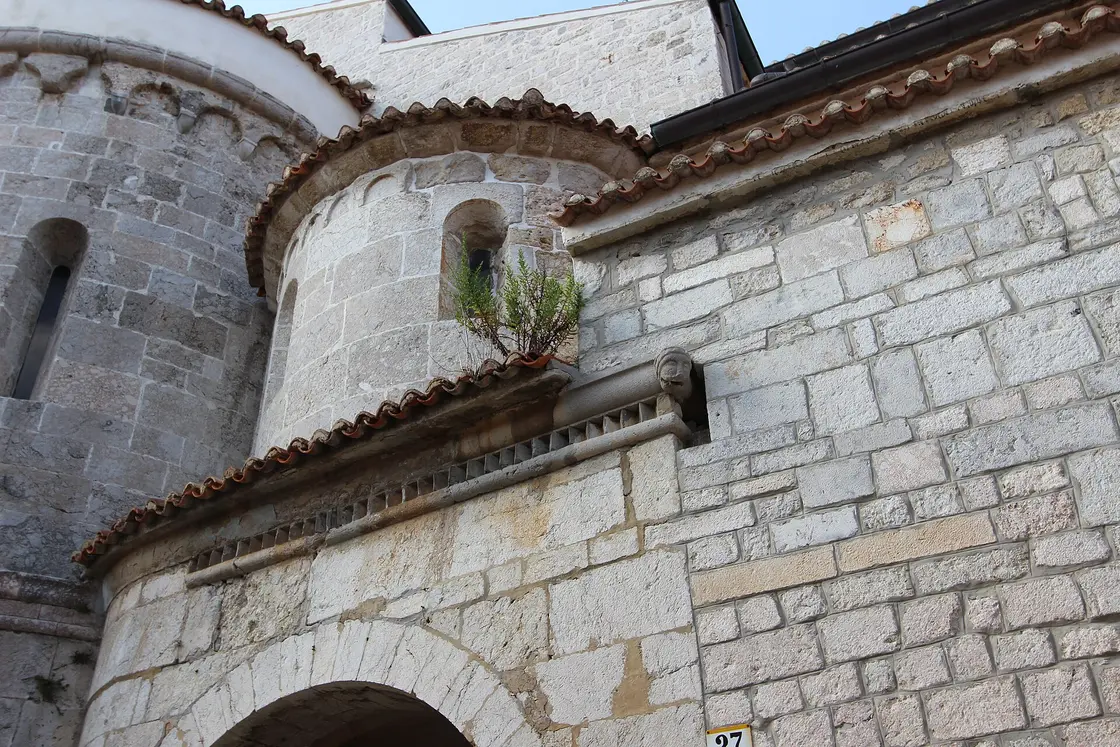 Romanesque apse and stone carving on the cathedral of the Assumption in Krk town