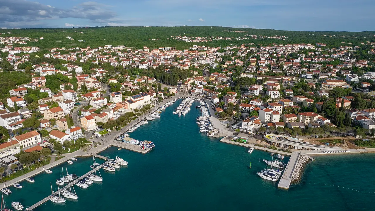 Aerial view of Malinska on Krk with its marina, waterfront and dense holiday housing behind