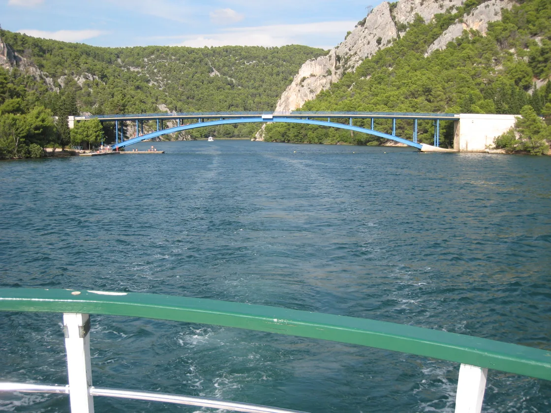 View from the deck of a boat on the Krka river toward the Skradin bridge
