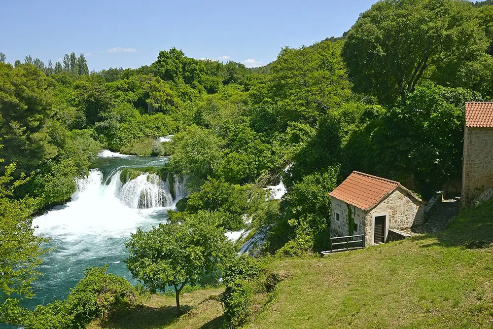 The Skradinski Buk cascades tumbling past a historic stone watermill at Krka