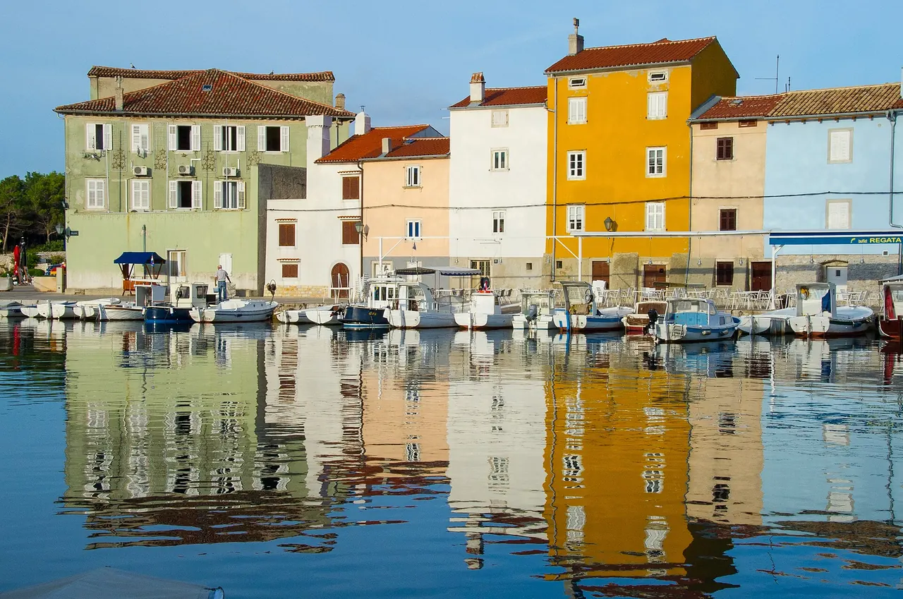 The harbour and terracotta roofs of Cres town seen across the water
