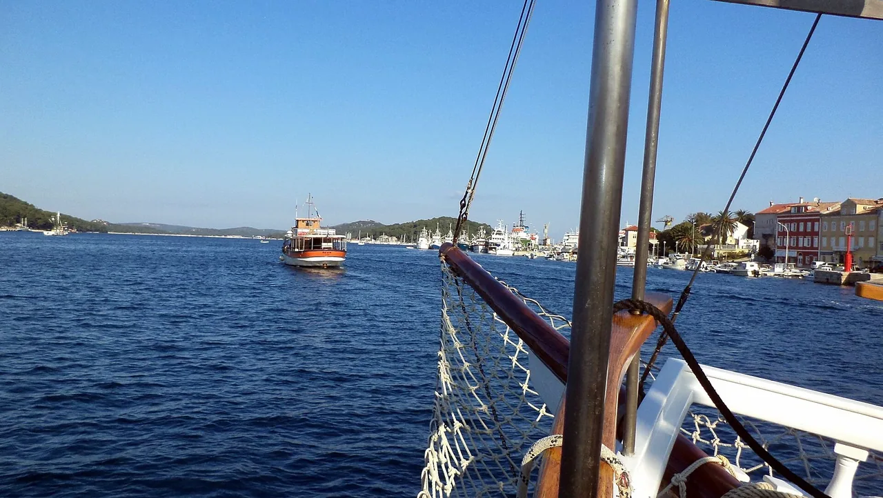 The channel at Mali Lošinj with the shipyard on one side and the road toward Veli Lošinj on the other