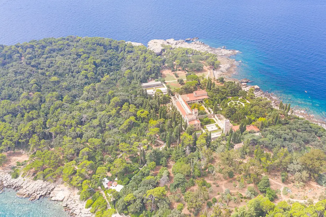Aerial view of the Benedictine monastery of St Mary on Lokrum surrounded by pine forest and the sea