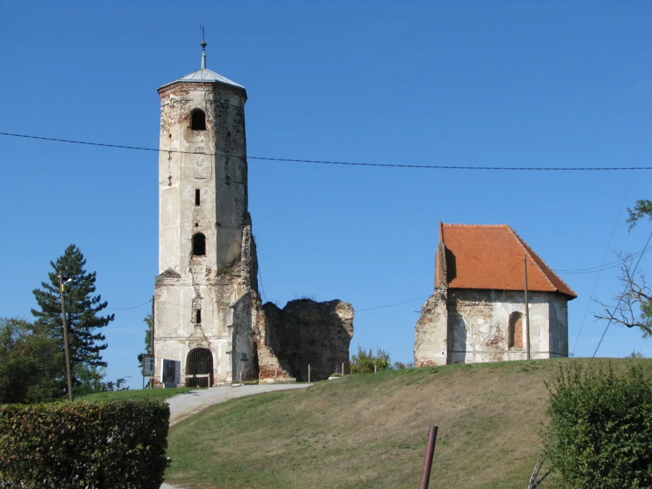 The ruined bell tower of the old St Martin church and a small chapel on the Martin Breg hill in Dugo Selo